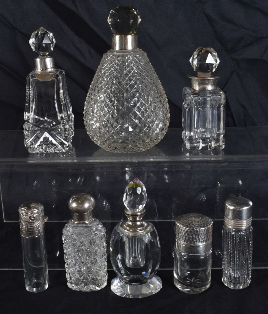 FIVE ANTIQUE SILVER MOUNTED SCENT BOTTLES together with three white metal mounted bottles. (8) (1 of 5)
