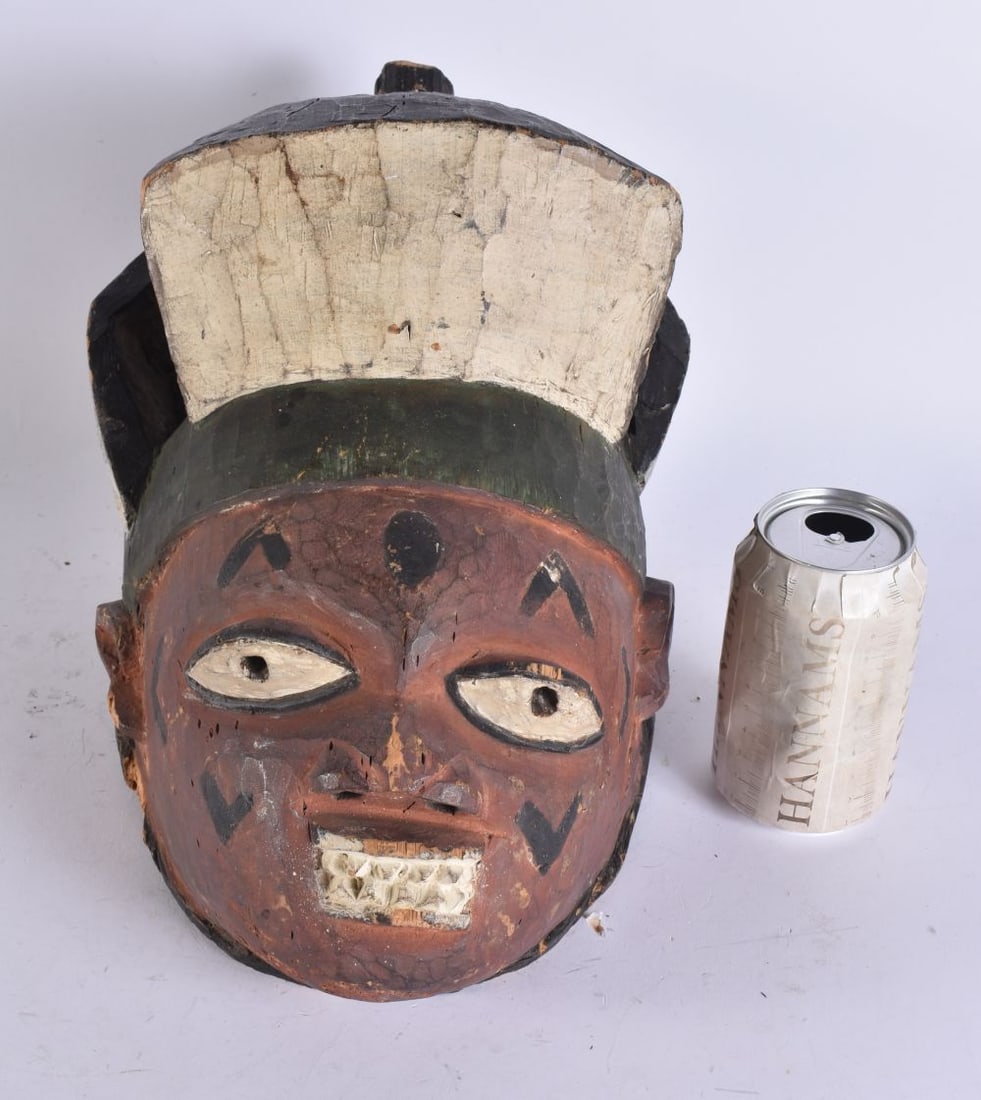 A TRIBAL PAINTED WOOD HELMET MASK. 32 cm x 15 cm. (1 of 5)