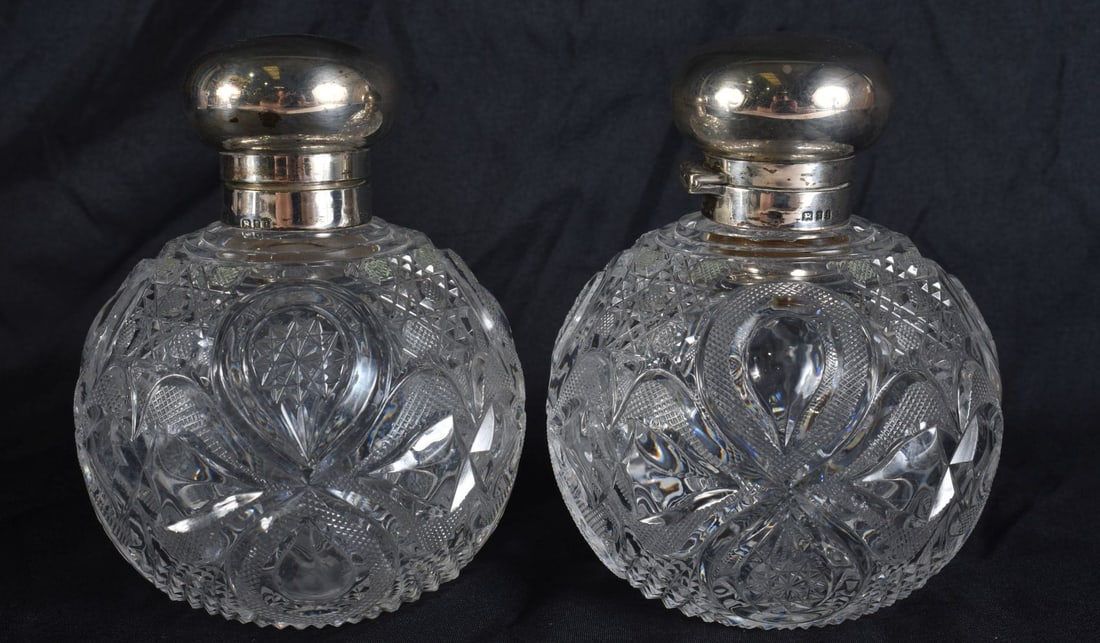 A PAIR OF ANTIQUE SILVER CUT GLASS SCENT BOTTLES. 11.5 cm high. (1 of 5)