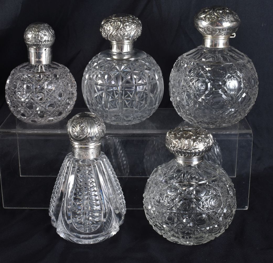 A GROUP OF FIVE ANTIQUE SILVER AND CUT GLASS SCENT BOTTLES. Largest 14 cm high. (5) (1 of 7)