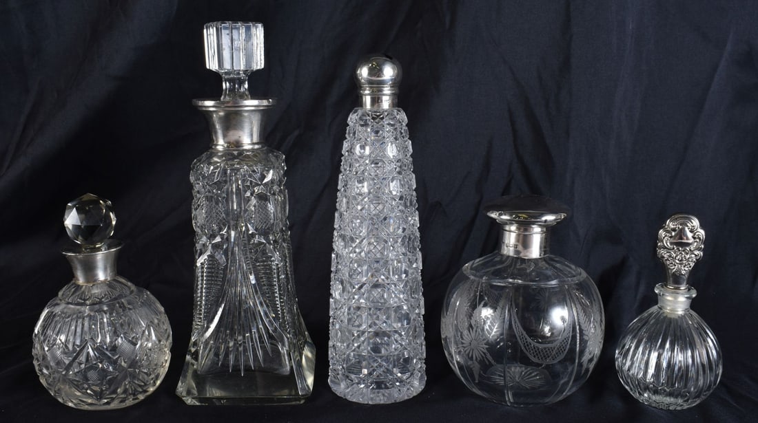 A GROUP OF FIVE ANTIQUE SILVER MOUNTED CUT GLASS SCENT BOTTLES. Largest 16 cm high. (5) (1 of 6)