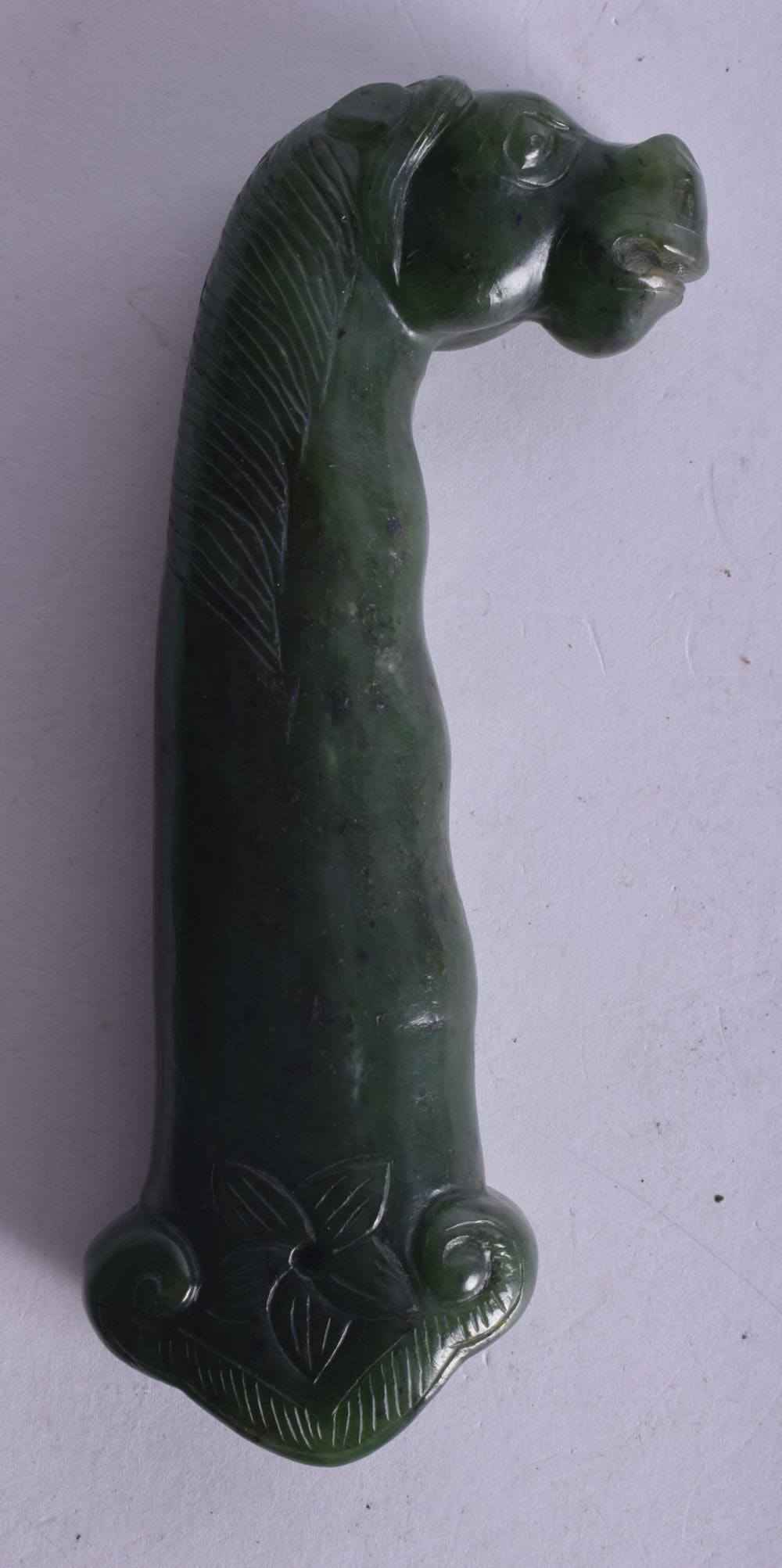 A 19TH CENTURY INDIAN MUGHAL SPINACH JADE DAGGER HANDLE formed as a horses head. 12.5 cm long. (1 of 3)