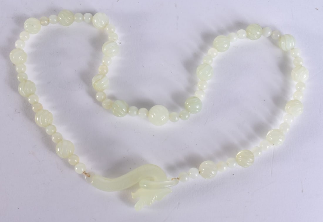 A CHINESE JADE BELT HOOK NECKLACE. 58 cm long. (1 of 4)