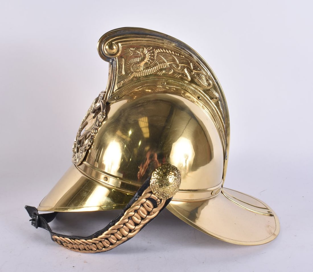 A BRASS FIREMAN'S HELMET. 27 cm x 33 cm. (1 of 4)