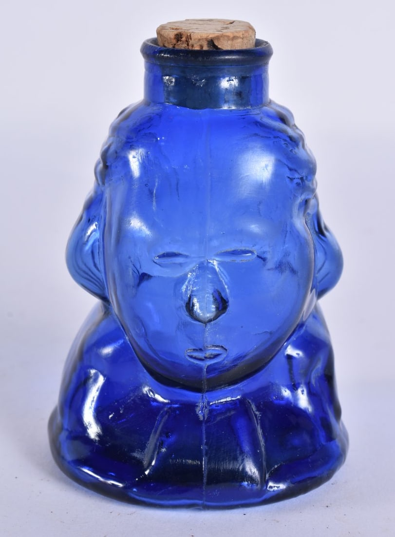 AN UNUSUAL GEORGE WASHINGTON BLUE GLASS BOTTLE. 10 cm high. (1 of 4)