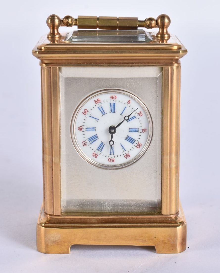 A SILVER DIAL MINIATURE CARRIAGE CLOCK. 7.5 cm high inc handle. (1 of 5)