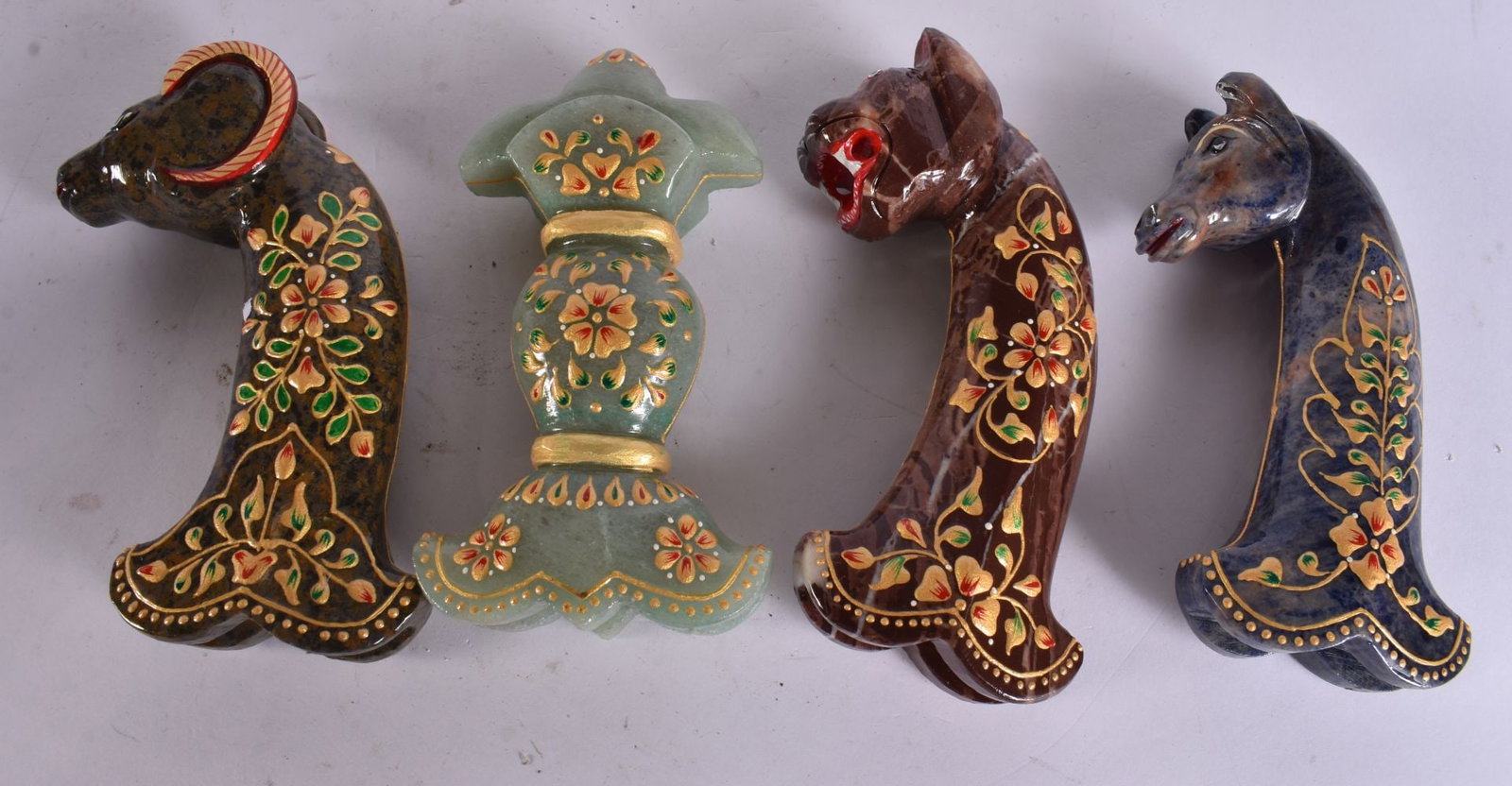 FOUR MUGHAL STONE LACQUERED DAGGER HANDLES. 15 cm long. (4): FOUR MUGHAL STONE LACQUERED DAGGER HANDLES. 15 cm long. (4)