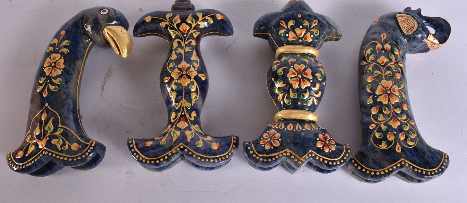 FOUR MUGHAL STONE LACQUERED DAGGER HANDLES. 15 cm long. (4) (1 of 3)