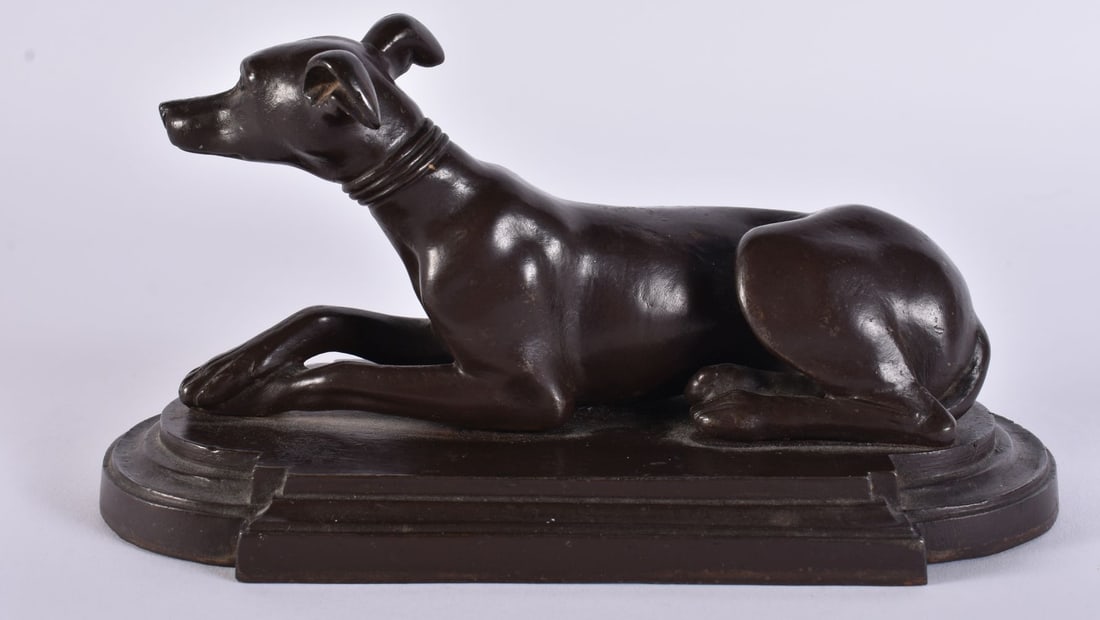 A VICTORIAN BRONZE FIGURE OF A RECUMBENT GREYHOUND. 17 cm x 10 cm.: A VICTORIAN BRONZE FIGURE OF A RECUMBENT GREYHOUND. 17 cm x 10 cm.