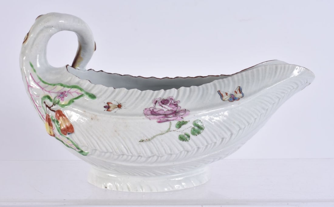 AN 18TH CENTURY WORCESTER COS LETTUCE MOULDED SAUCEBOAT painted with butterflies and foliage. 18 cm: AN 18TH CENTURY WORCESTER COS LETTUCE MOULDED SAUCEBOAT painted with butterflies and foliage. 18 cm wide.