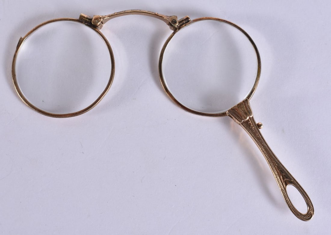 A PAIR OF YELLOW METAL LORGNETTES. 12 cm wide extended. (1 of 3)