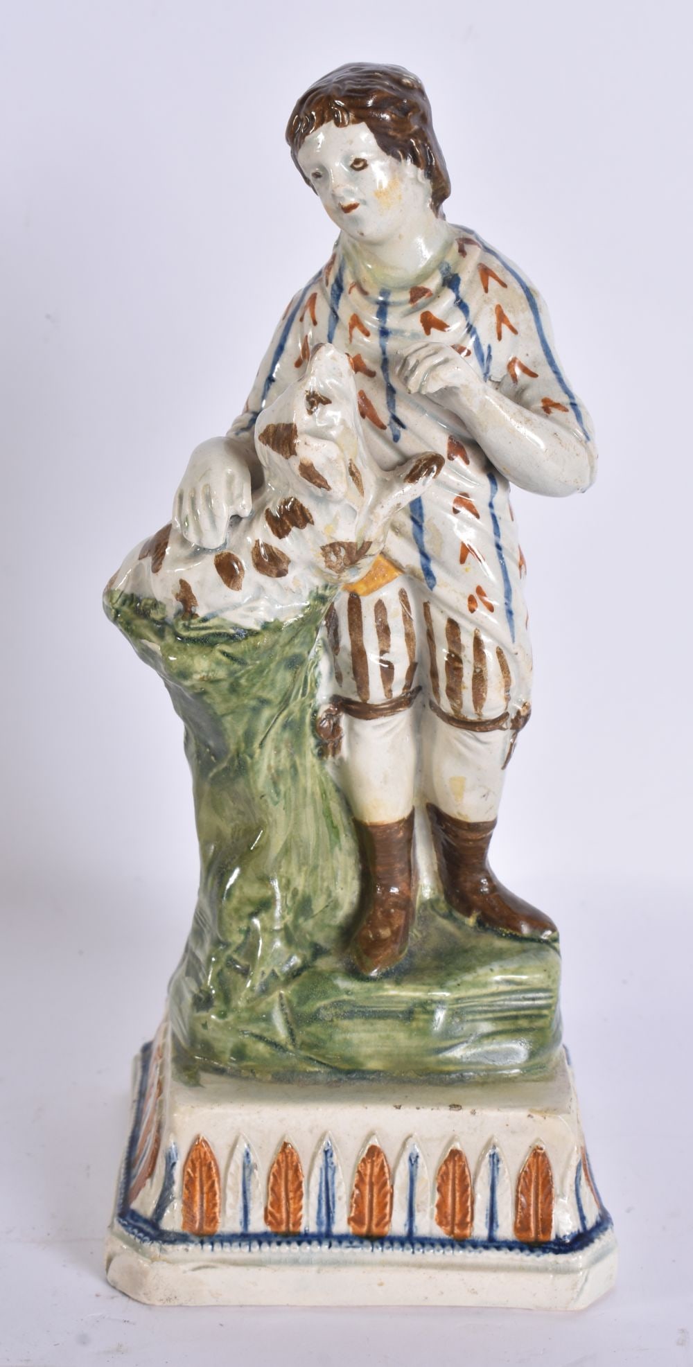 AN EARLY 19TH CENTURY CREAMWARE FIGURE OF A FEMALE modelled holding a dog. 21 cm high.: AN EARLY 19TH CENTURY CREAMWARE FIGURE OF A FEMALE modelled holding a dog. 21 cm high.