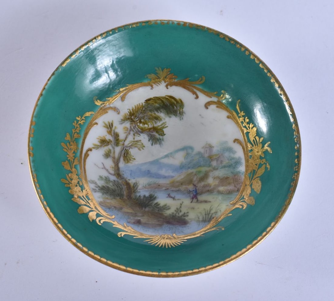 A SMALL 18TH/19TH CENTURY SEVRES PORCELAIN SAUCER painted with a figures in a landscape. 9.5 cm wide: A SMALL 18TH/19TH CENTURY SEVRES PORCELAIN SAUCER painted with a figures in a landscape. 9.5 cm wide.