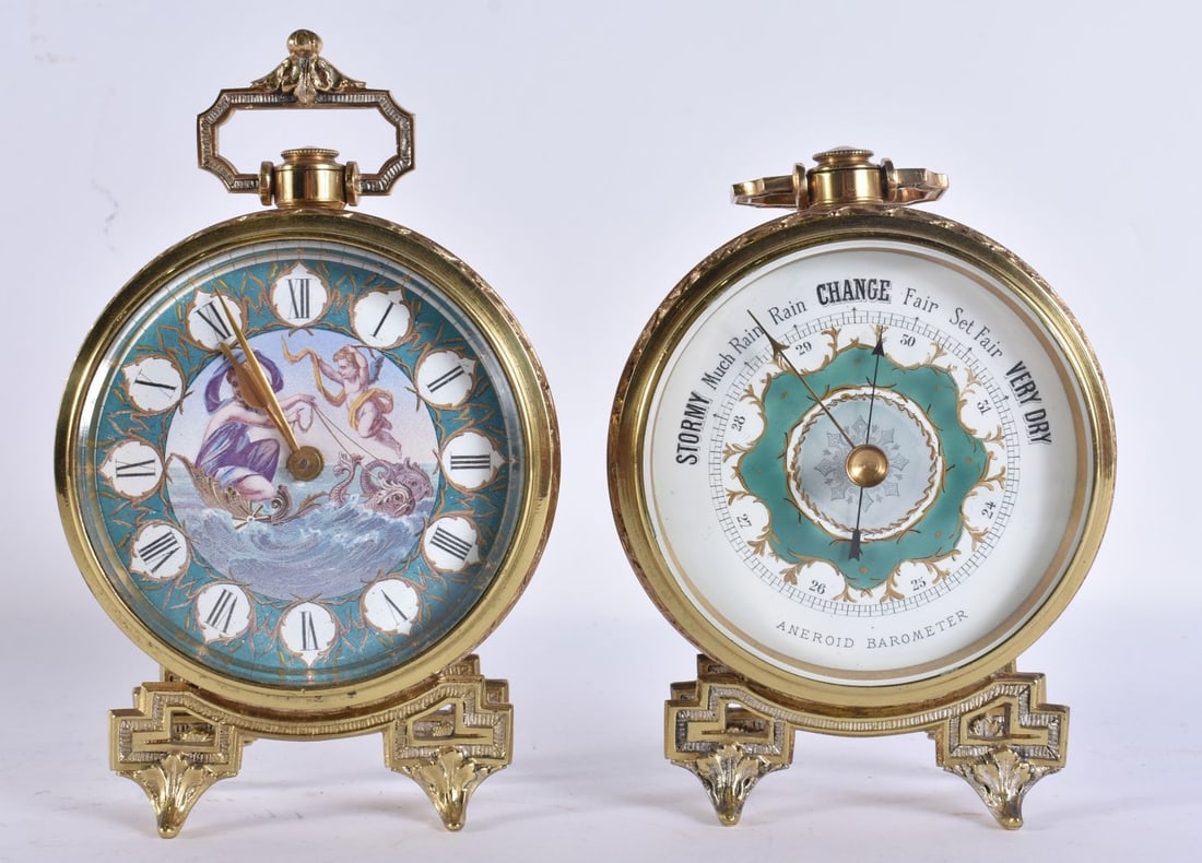A PAIR OF ANTIQUE GILT METAL FRENCH BRASS CLOCKS/BAROMETERS formed as drums upon open work feet. 17: A PAIR OF ANTIQUE GILT METAL FRENCH BRASS CLOCKS/BAROMETERS formed as drums upon open work feet. 17 cm x 8 cm.