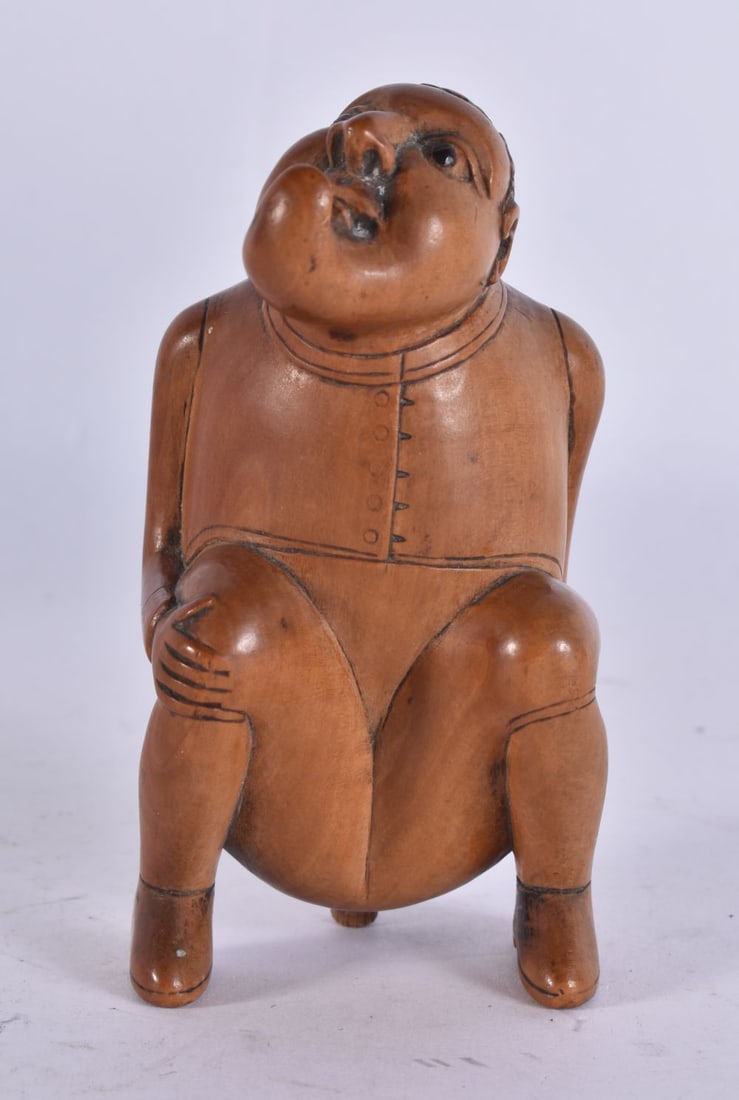 AN EARLY 19TH CENTURY EUROPEAN CARVED WOOD TREEN SNUFF BOX modelled as a defecating male. 9 cm high. (1 of 4)