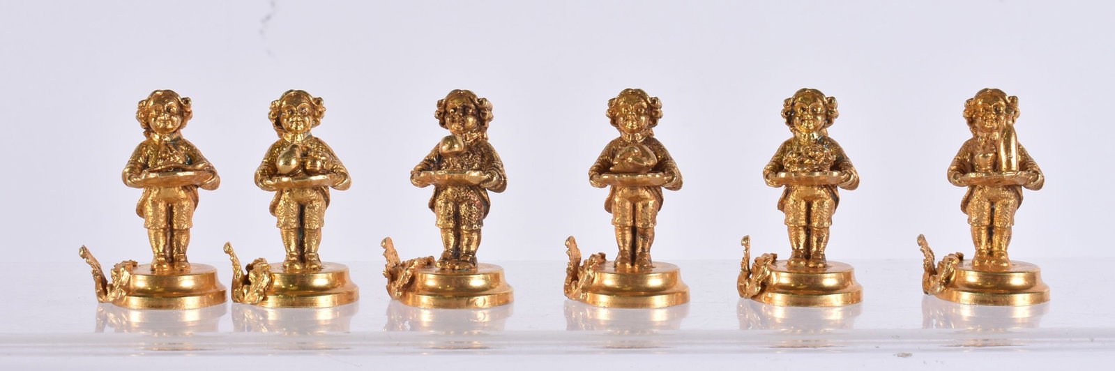 A SET OF SIX 20TH CENTURY ITALIAN SILVER GILT PLACE CARD HOLDERS IN THE FORM OF SERVANTS each modell (1 of 4)