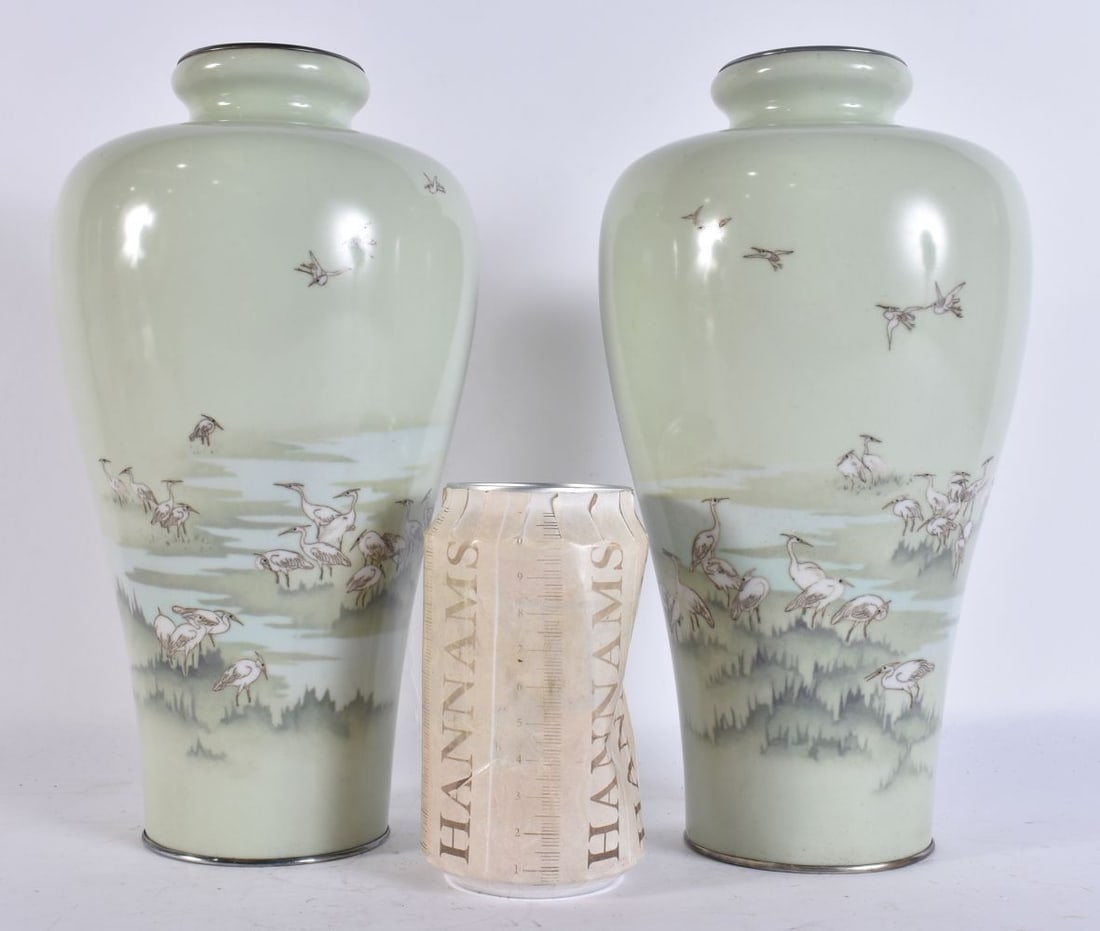 HAYASHI KIHOE A PAIR OF MEIJI PERIOD JAPANESE CLOISONNE VASES of tapering ovoid form with short ever: HAYASHI KIHOE A PAIR OF MEIJI PERIOD JAPANESE CLOISONNE VASES of tapering ovoid form with short everted necks and silvered metal rims, decorated in wireless cloisonne on a pale celadon ground with flo