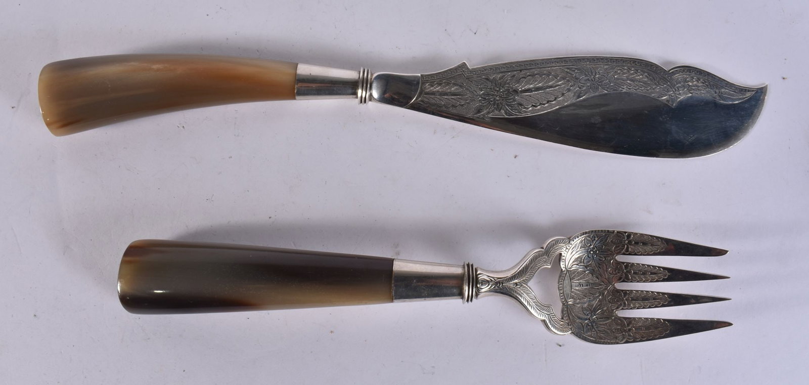 A PAIR OF ISLAMIC SILVER SERVING UTENSILS WITH HORN HANDLES . 348 grams overall. 34 cm long. (1 of 4)