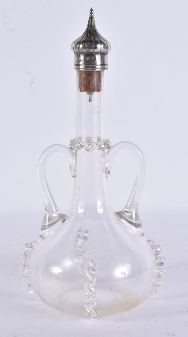 AN ANTIQUE SILVER MOUNTED GLASS DECANTER. 20 cm high. (1 of 3)