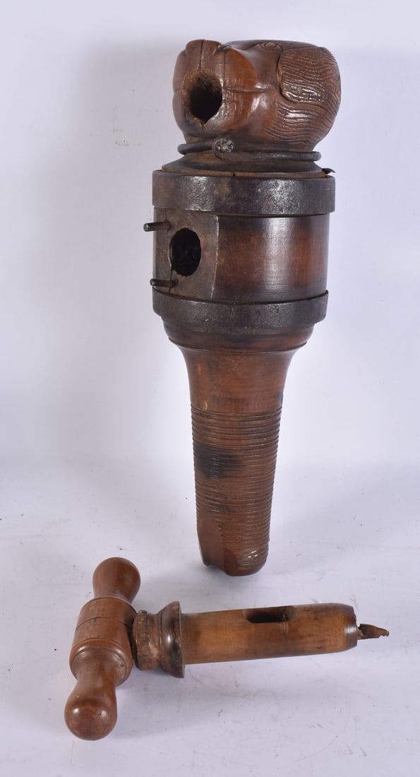 A 19TH CENTURY CARVED WOOD AND IRON BARREL TAP/CASK BORER the carved dog's head terminal above a cyl (1 of 8)
