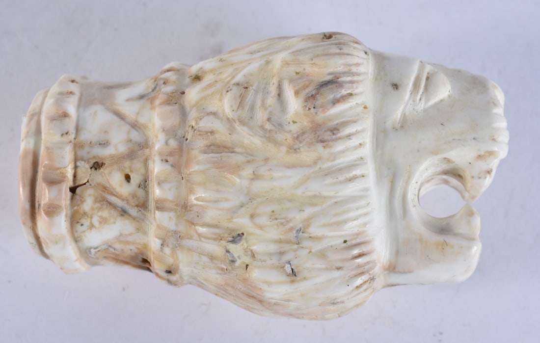 A 19TH CENTURY CARVED STONE LIONS HEAD WITH PIERCED APERTURE carved in relief with stylised mane and (1 of 4)