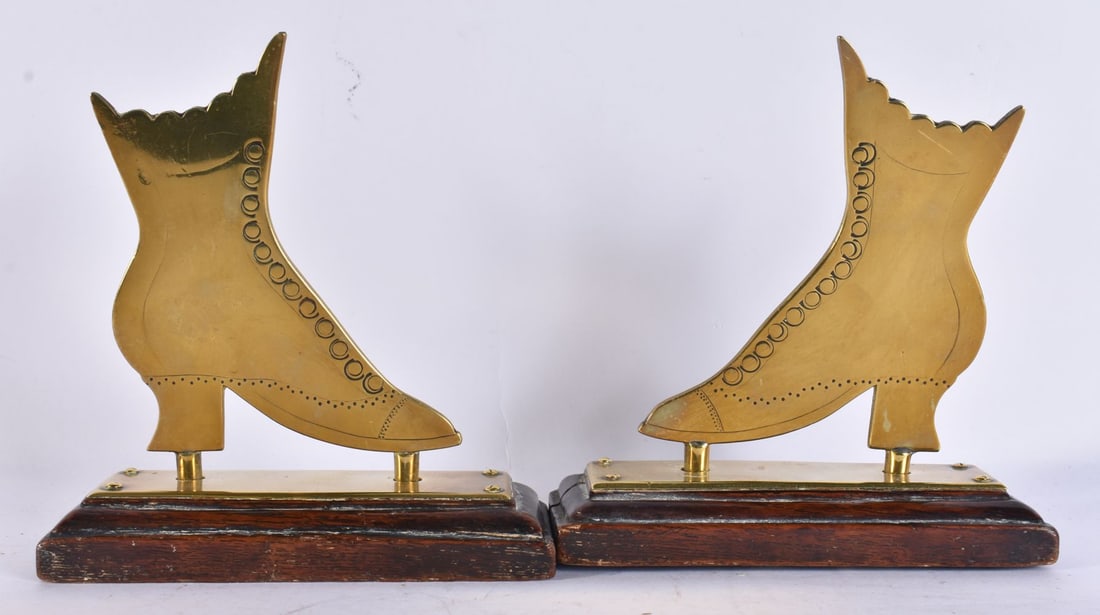 A PAIR OF ANTIQUE BRASS BOOT CANDLE GUARDS. 15 cm x 12 cm.: A PAIR OF ANTIQUE BRASS BOOT CANDLE GUARDS. 15 cm x 12 cm.