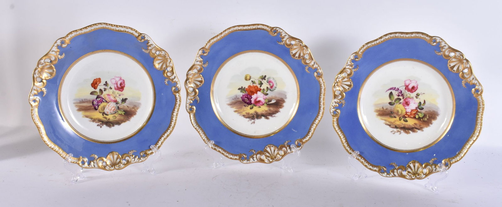 A SET OF THREE 19TH CENTURY ENGLISH PORCELAIN PLATES painted with flowers. 23 cm wide. (3) (1 of 8)