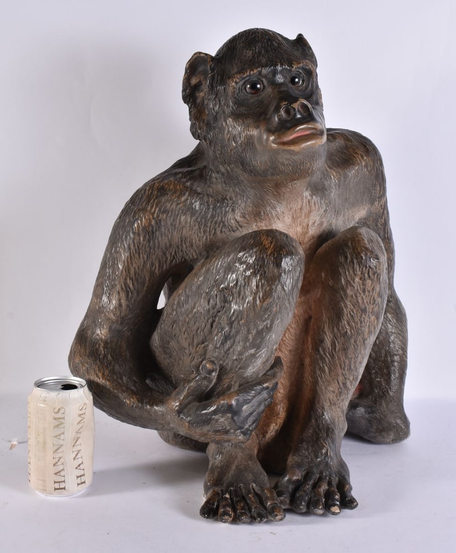 A 19TH CENTURY AUSTRIAN TERRACOTTA SCULPTURE OF A SEATED MONKEY naturalistically modelled in a crouc (1 of 4)