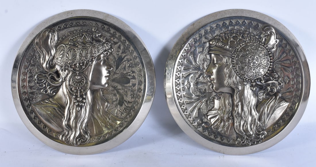 A PAIR OF ART NOUVEAU SILVERED BRONZE RELIEF PLAQUES OF BYZANTINE HEADS each of circular form with p: A PAIR OF ART NOUVEAU SILVERED BRONZE RELIEF PLAQUES OF BYZANTINE HEADS each of circular form with profile busts wearing elaborate headdresses within geometric borders stamped 2059 and 2058. 22.5 cm w