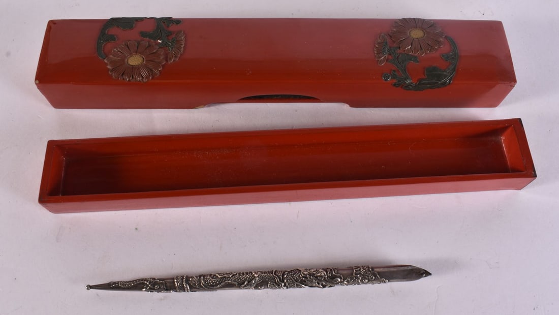 A JAPANESE RED LACQUER PEN BOX AND A SILVER METAL DRAGON PEN of long rectangular form with applied c (1 of 4)