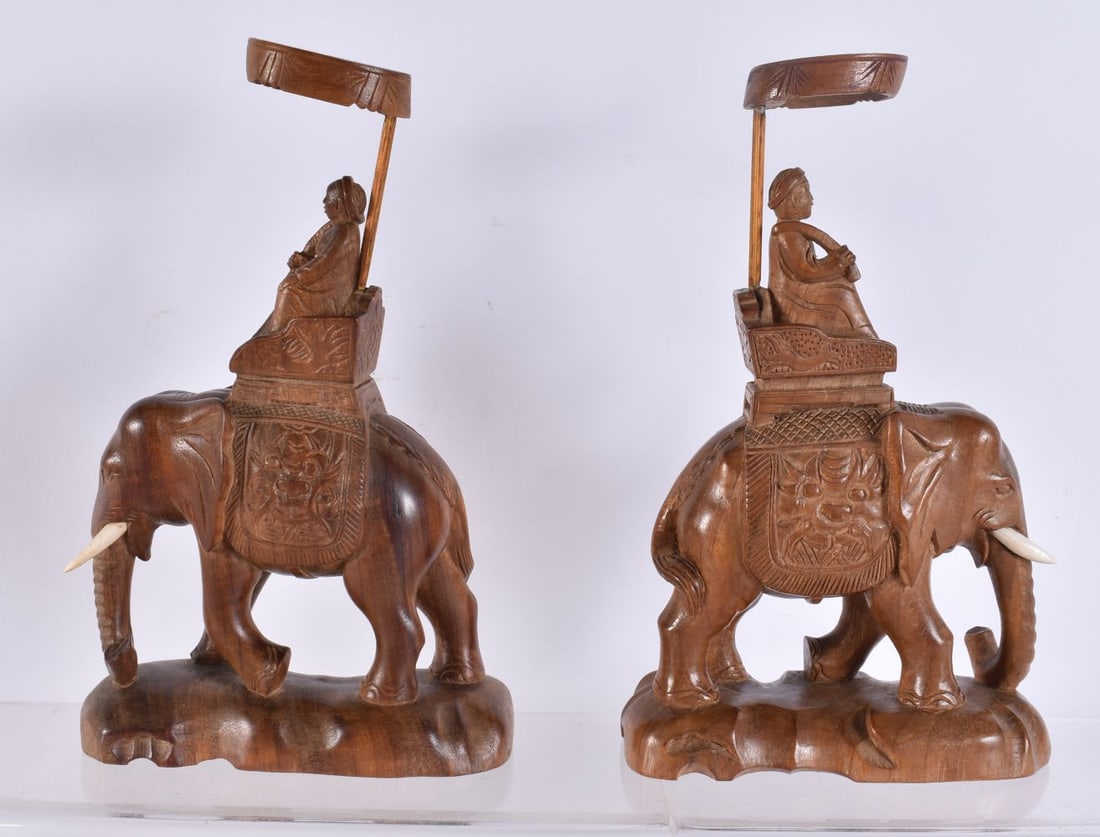 A PAIR OF INDIAN CARVED WOOD ELEPHANT FIGURES. 20 cm high. (1 of 4)