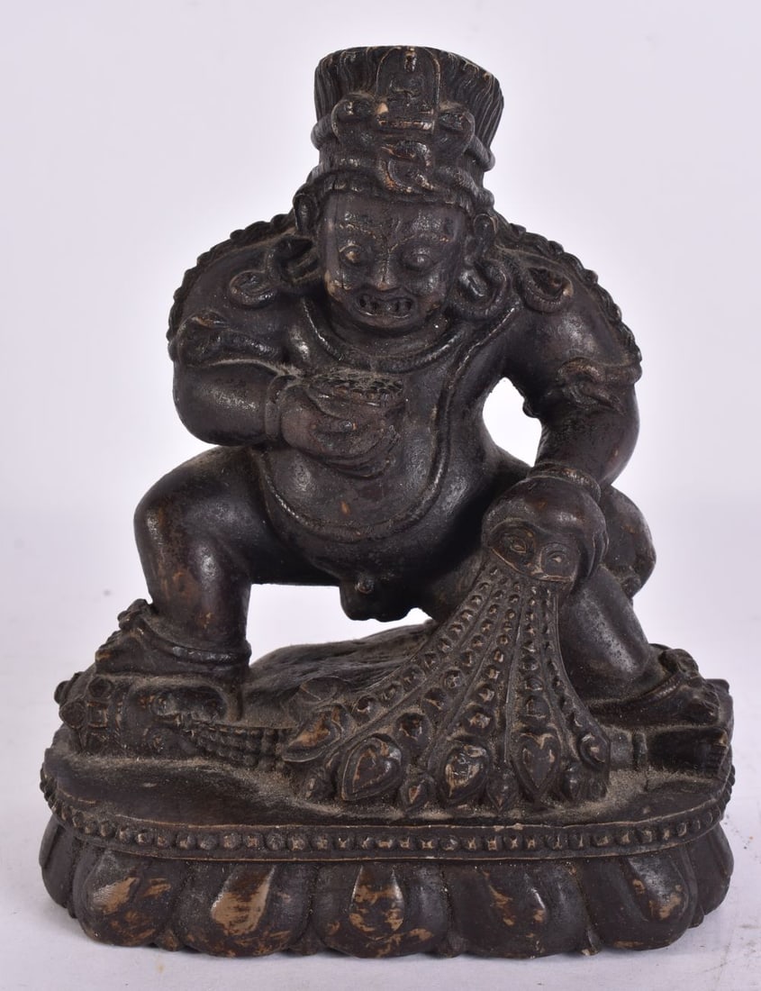 AN 18TH/19TH CENTURY TIBETAN CARVED STONE FIGURE OF A BUDDHIST DEITY modelled stomping on another de (1 of 15)