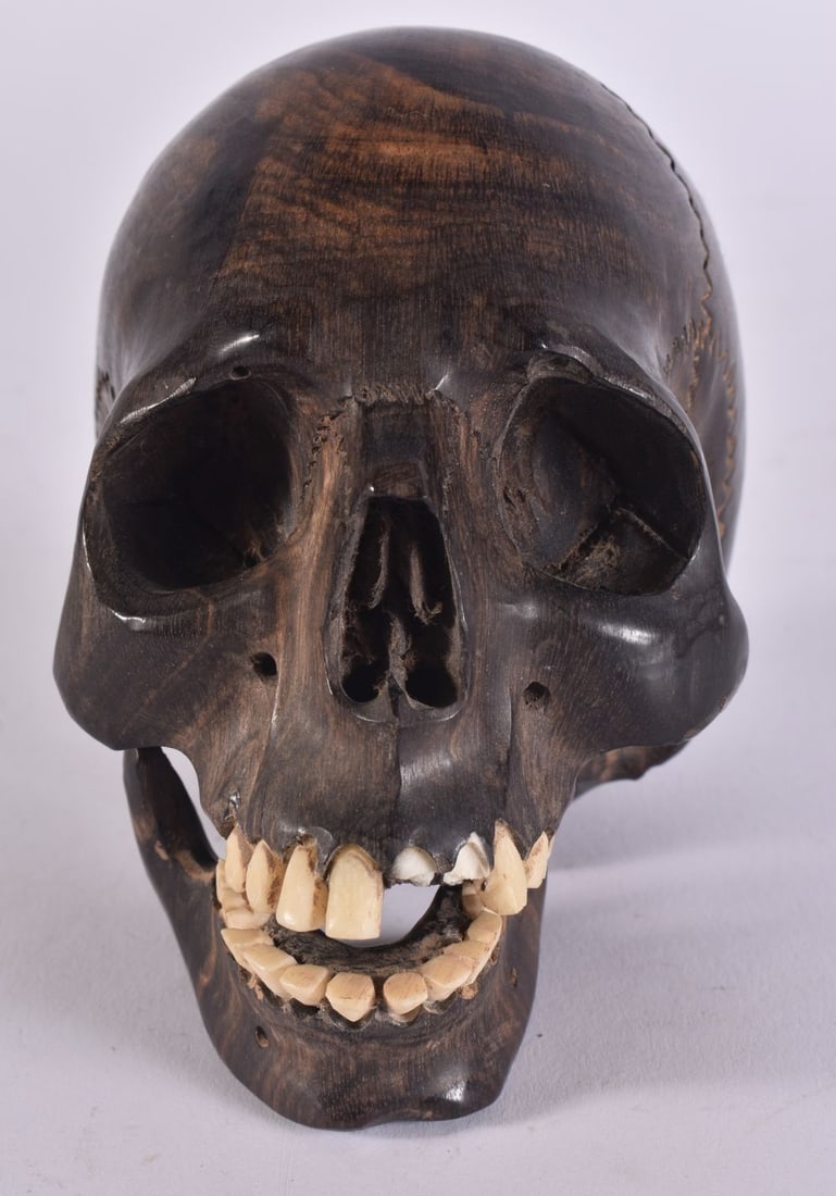 AN EARLY 20TH CENTURY TREEN LIGNUM VITAE ARTICULATED SKULL. 12 cm x 8 cm. (1 of 5)