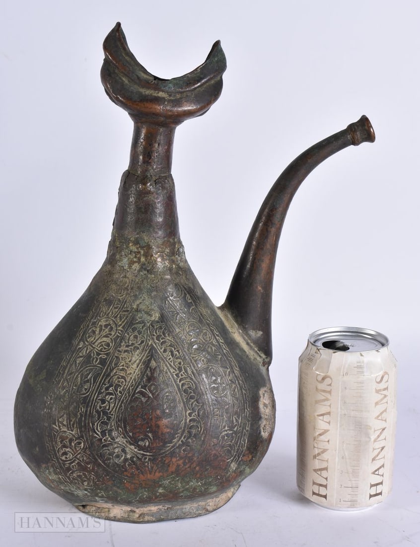 A 15TH/16TH CENTURY ISLAMIC MIDDLE EASTERN EWER decorated with extensive motifs and two separate sea (1 of 12)