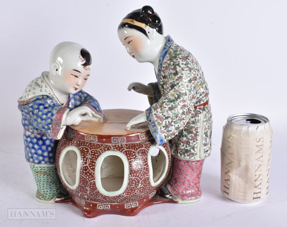 AN UNUSUAL CHINESE REPUBLICAN PERIOD PORCELAIN FIGURE modelled as a mother and child beside a barrel (1 of 5)