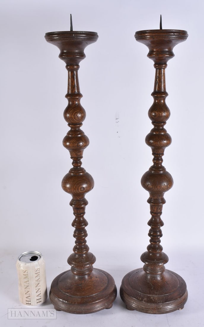 A PAIR OF ANTIQUE OAK PRICKET CANDLESTICKS. 65 cm high.: A PAIR OF ANTIQUE OAK PRICKET CANDLESTICKS. 65 cm high.
