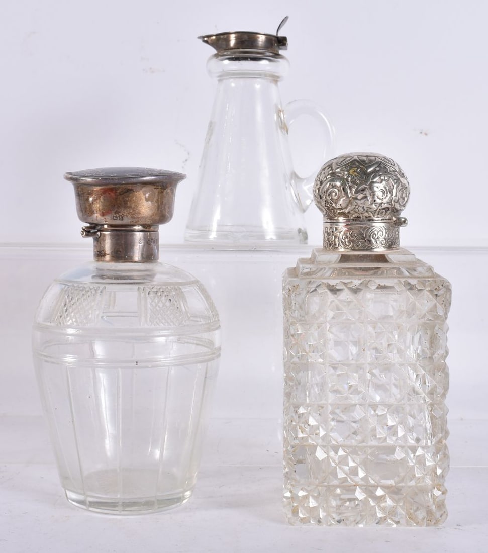TWO ANTIQUE SILVER MOUNTED SCENT BOTTLES together with a silver mounted whiskey noggin. Largest 14 c (1 of 6)