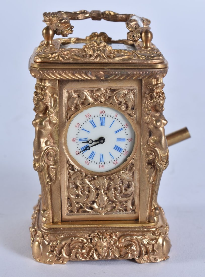 A MINIATURE GILT CARRIAGE CLOCK. Running. 9 cm high inc handle. (1 of 7)