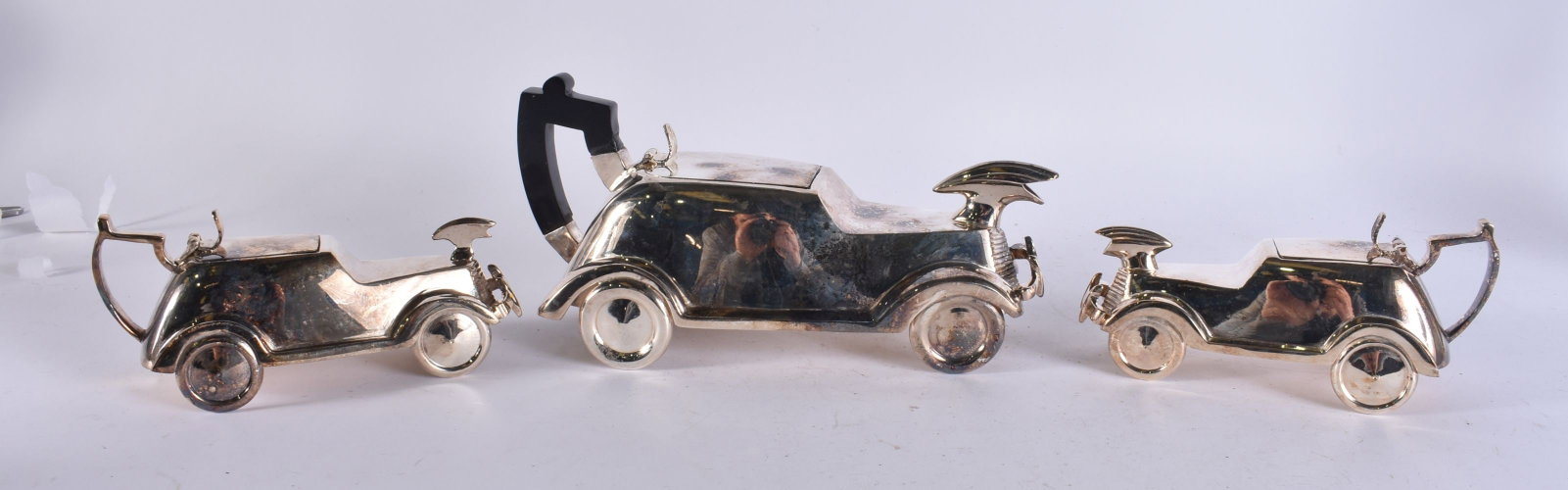 A TRIO OF SILVER PLATED AUTOMOTIVE CRUETS. 17 cm wide. (1 of 5)