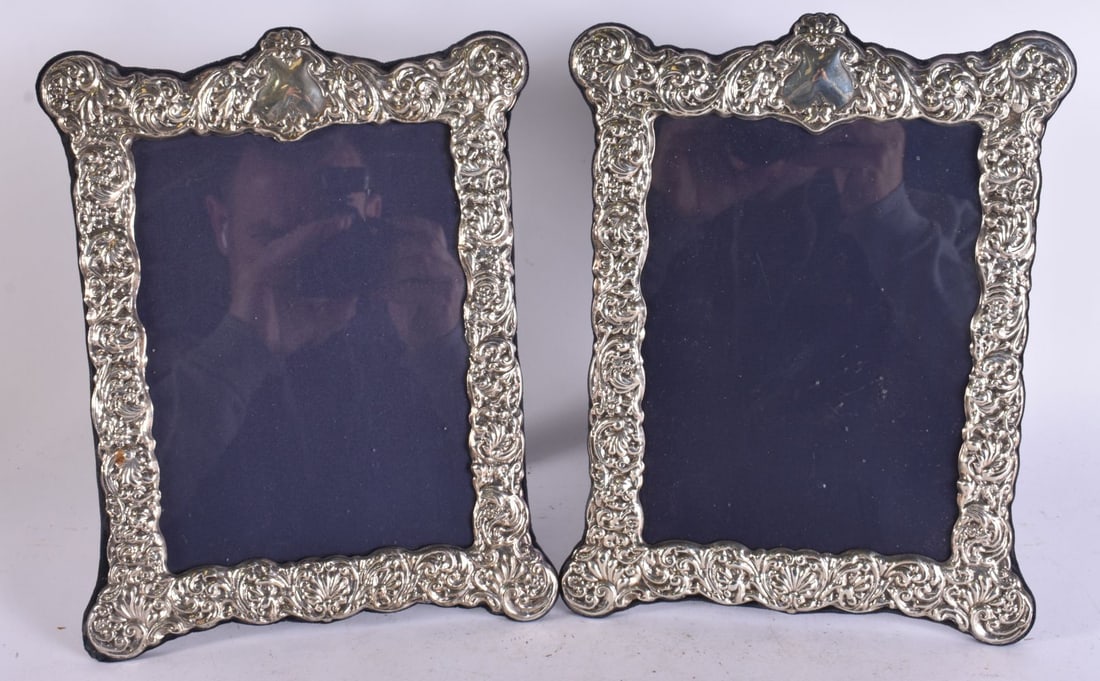 A PAIR OF SILVER PHOTOGRAPH FRAMES. 1100 grams overall. 30 cm x 22 cm. (1 of 5)