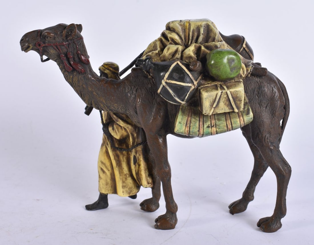 A COLD PAINTED BRONZE ARABIC CAMEL GROUP. 14 cm x 12 cm. (1 of 5)