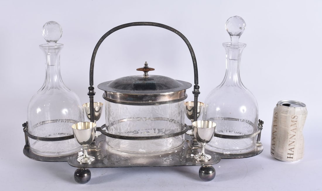 A SILVER PLATED BISCUIT BARREL DECANTER SET. 45 cm x 29 cm.: A SILVER PLATED BISCUIT BARREL DECANTER SET. 45 cm x 29 cm.