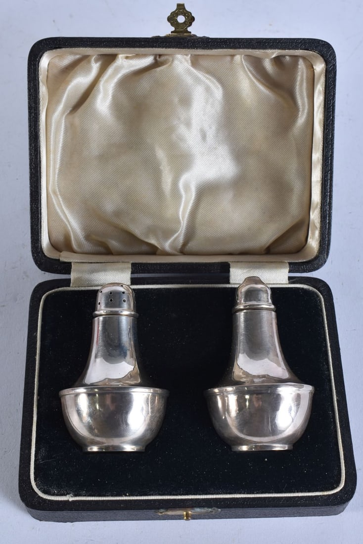 A PAIR OF SILVER CONDIMENTS. 58 grams. 7 cm high. (1 of 5)