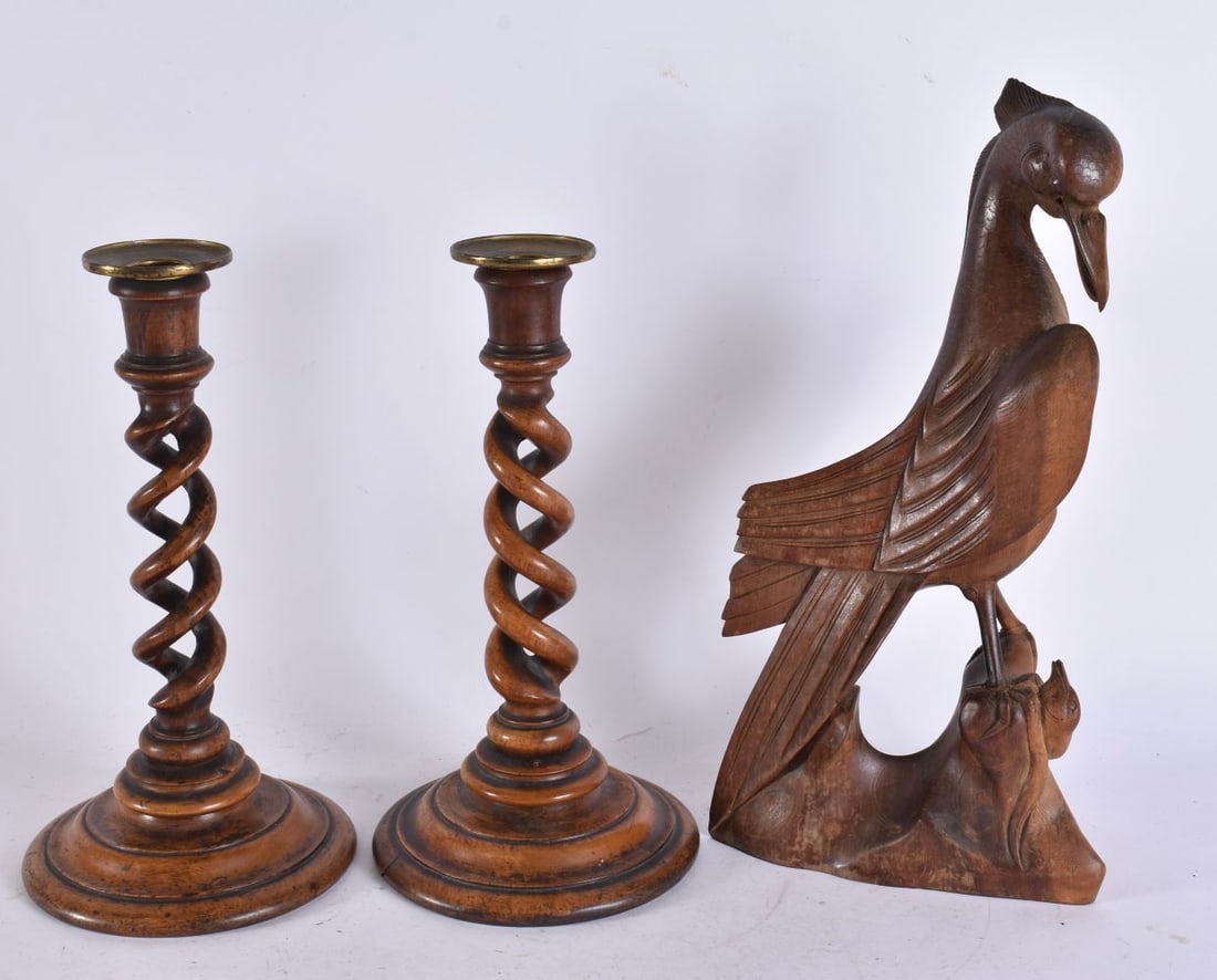 A PAIR OF ANTIQUE BARLEY TWIST CANDLESTICKS together with a figure of a bird. Largest 33 cm high. (3: A PAIR OF ANTIQUE BARLEY TWIST CANDLESTICKS together with a figure of a bird. Largest 33 cm high. (3)