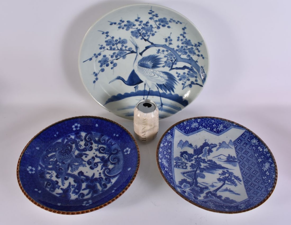 A 19TH CENTURY JAPANESE MEIJI PERIOD BLUE AND WHITE DISH together with two others. Largest 32 cm wid: A 19TH CENTURY JAPANESE MEIJI PERIOD BLUE AND WHITE DISH together with two others. Largest 32 cm wide. (3)