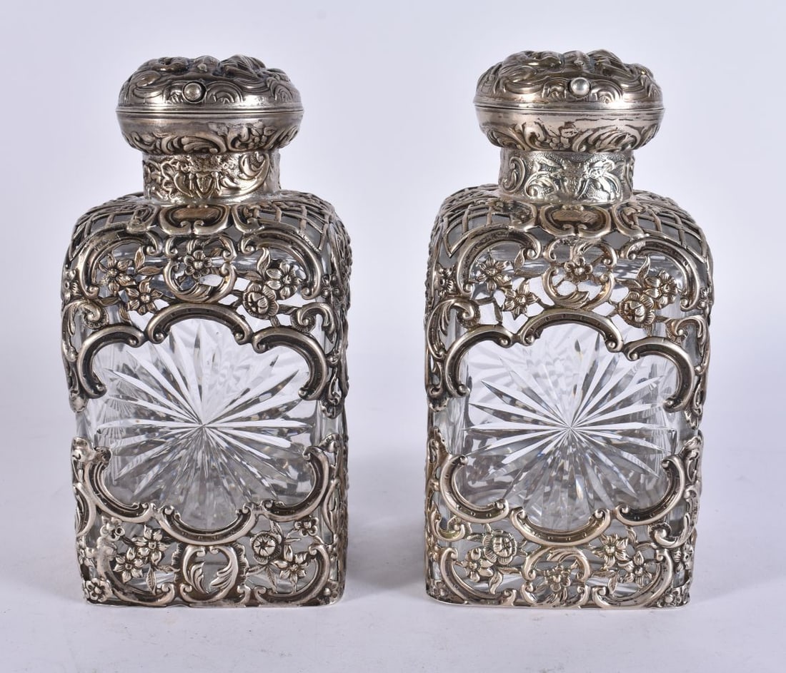 A PAIR OF VICTORIAN SILVER OVERLAID SCENT BOTTLES. London 1895. 1352 grams overall. 14 cm high. (1 of 4)