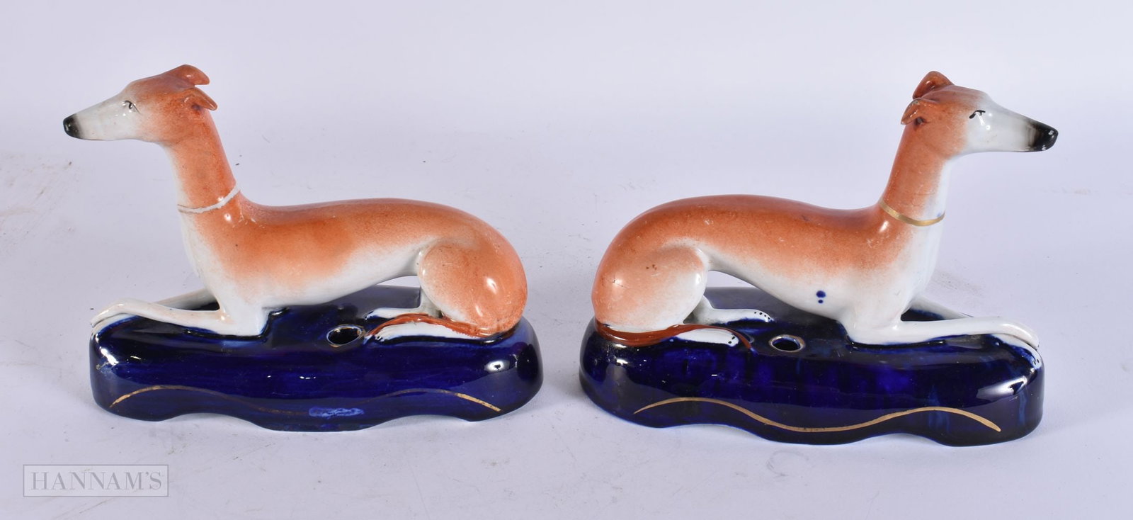 A PAIR OF VICTORIAN STAFFORDSHIRE GREYHOUNDS. 15 cm x 13 cm.: A PAIR OF VICTORIAN STAFFORDSHIRE GREYHOUNDS. 15 cm x 13 cm.