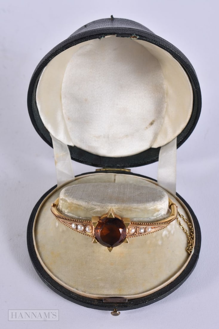 A VICTORIAN YELLOW METAL PEARL AND GEM STONE BANGLE. 14 grams. 6.75 cm wide.: A VICTORIAN YELLOW METAL PEARL AND GEM STONE BANGLE. 14 grams. 6.75 cm wide.