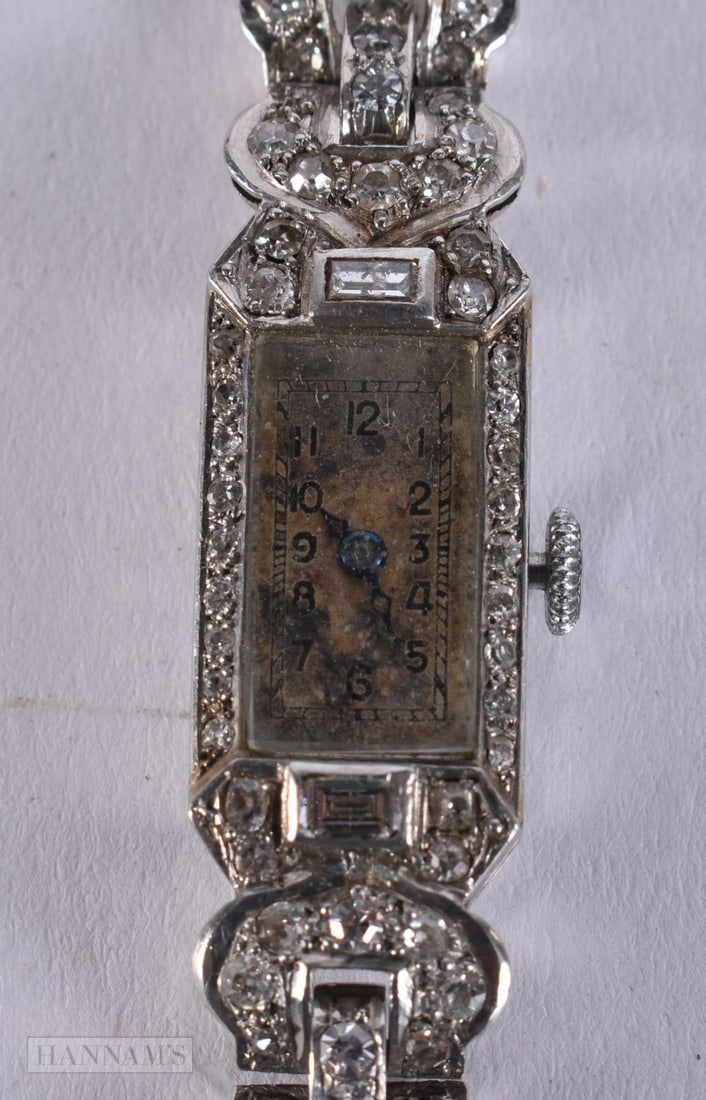 AN ANTIQUE PLATINUM AND DIAMOND COCKTAIL WATCH. 22 grams overall. Not running. 16 cm long, dial 2.5: AN ANTIQUE PLATINUM AND DIAMOND COCKTAIL WATCH. 22 grams overall. Not running. 16 cm long, dial 2.5 cm x 1.25 cm.