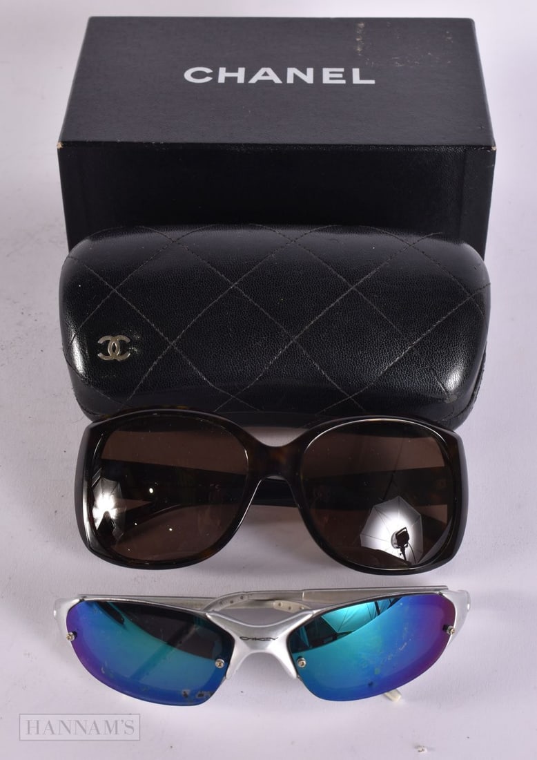 A PAIR OF CHANEL SUNGLASSES and a pair of Oakley glasses. (2) We are UNABLE to offer in-House shipp: A PAIR OF CHANEL SUNGLASSES and a pair of Oakley glasses. (2) We are UNABLE to offer in-House shipping to USA or Canada on this Lot